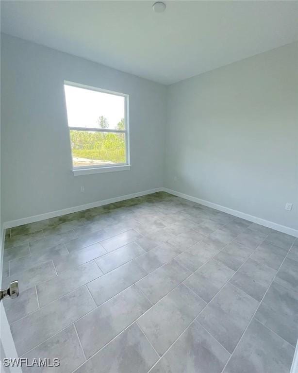 2864 68th Ave NE, Naples, FL 34120 - spare room featuring baseboards and tile patterned floors