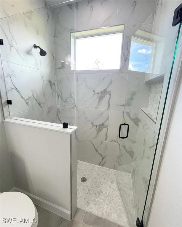 2864 68th Ave NE, Naples, FL 34120 - full bathroom featuring a marble finish shower and toilet