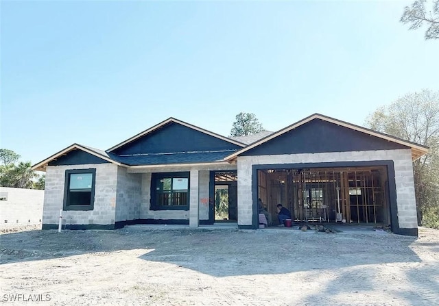 view of front of home featuring an attached garage and roof with shingles
