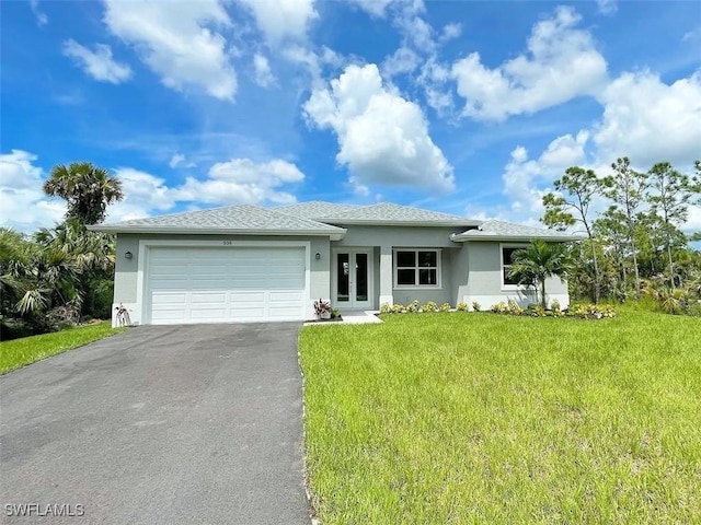 view of front of home featuring aphalt driveway, stucco siding, a front yard, an attached garage, and french doors