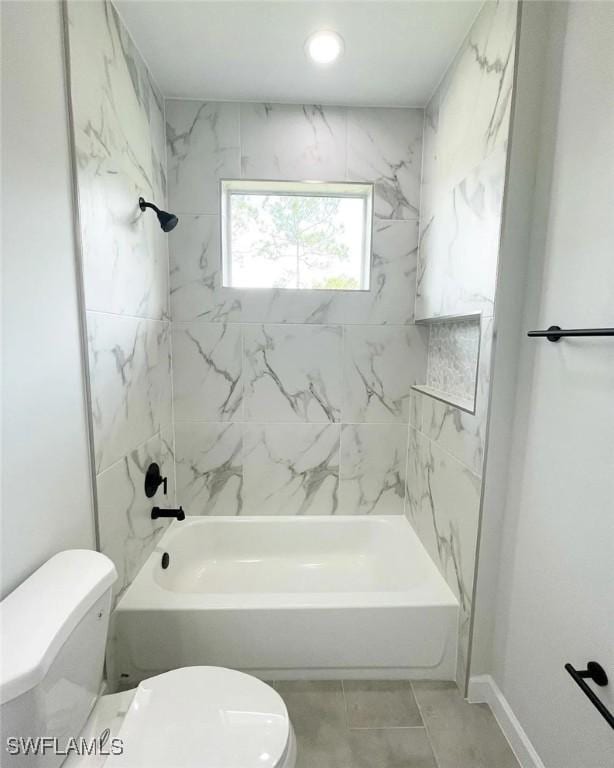full bath with tile patterned floors, toilet, shower / bath combination, and baseboards