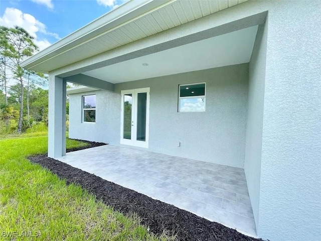 back of house with a patio, french doors, and stucco siding