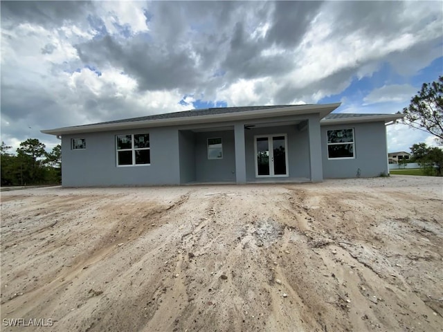 2864 68th Ave NE, Naples, FL 34120 - rear view of house with stucco siding and french doors