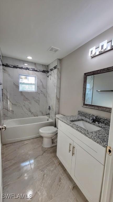 1138 Argosy Rd, Labelle, FL 33935 - bathroom with toilet, washtub / shower combination, vanity, marble finish flooring, and recessed lighting