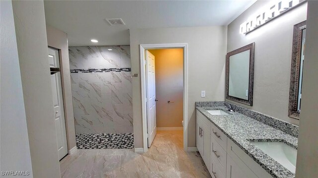 1138 Argosy Rd, Labelle, FL 33935 - full bathroom with a marble finish shower, double vanity, toilet, recessed lighting, and marble look tiles