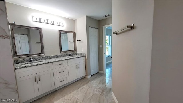 1138 Argosy Rd, Labelle, FL 33935 - full bath featuring marble look tiles, double vanity, and baseboards