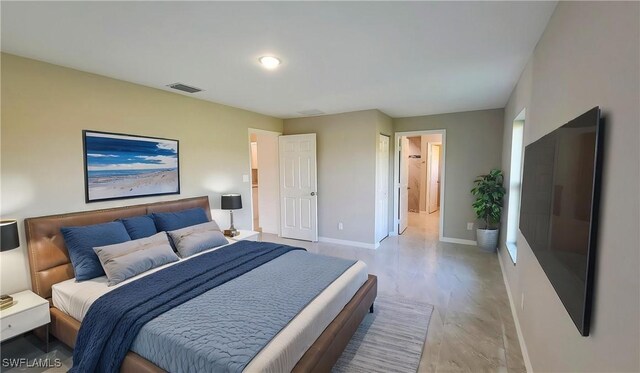 1138 Argosy Rd, Labelle, FL 33935 - bedroom with baseboards, light wood-type flooring, and ensuite bathroom