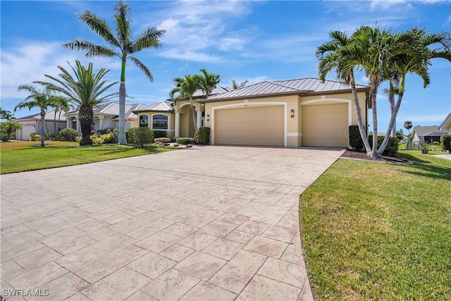 144 SW 54th Ter, Cape Coral, FL 33914 - view of front facade featuring an attached garage, stucco siding, decorative driveway, a front yard, and a standing seam roof