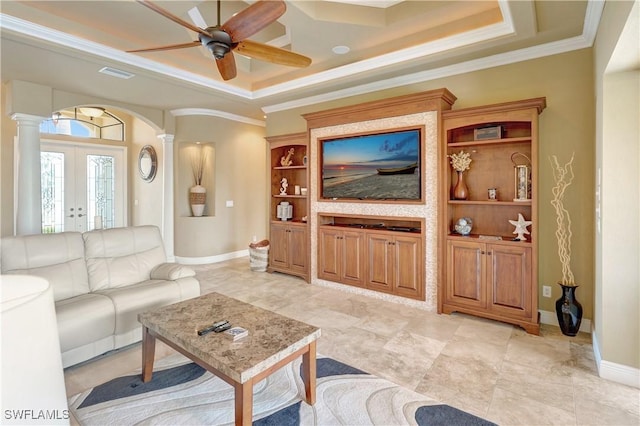 144 SW 54th Ter, Cape Coral, FL 33914 - living room featuring decorative columns, crown molding, ceiling fan, arched walkways, and a tray ceiling