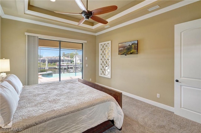 144 SW 54th Ter, Cape Coral, FL 33914 - bedroom with a tray ceiling, carpet floors, crown molding, baseboards, and access to outside