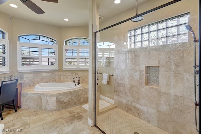 144 SW 54th Ter, Cape Coral, FL 33914 - bathroom featuring tiled shower, a bath, a ceiling fan, and a healthy amount of sunlight