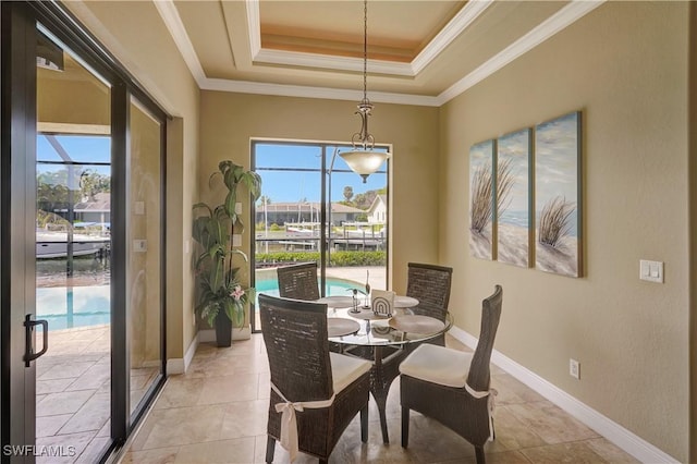 144 SW 54th Ter, Cape Coral, FL 33914 - dining area with a tray ceiling, ornamental molding, baseboards, and a healthy amount of sunlight
