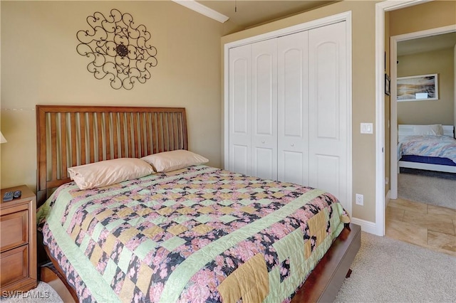 144 SW 54th Ter, Cape Coral, FL 33914 - bedroom with a closet, light carpet, and baseboards