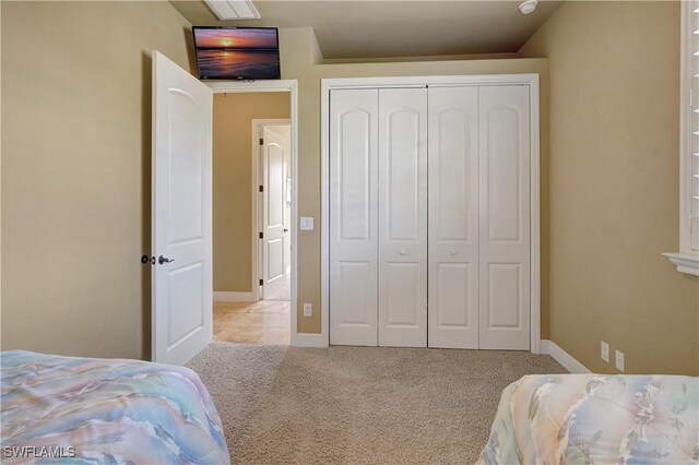 144 SW 54th Ter, Cape Coral, FL 33914 - bedroom with carpet flooring, a closet, and baseboards