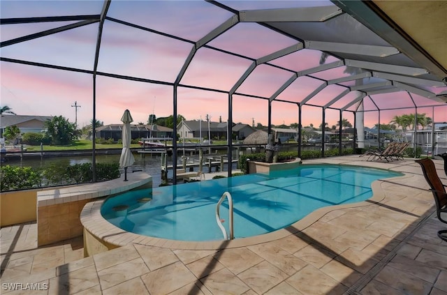 144 SW 54th Ter, Cape Coral, FL 33914 - pool at dusk with a patio, an outdoor pool, a water view, a boat dock, and boat lift