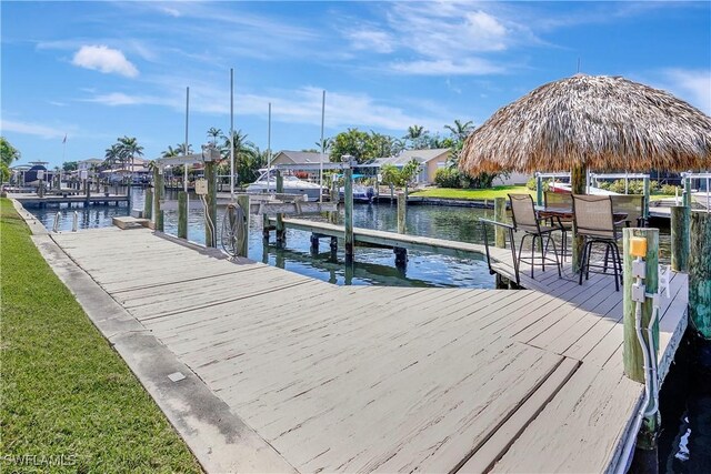 144 SW 54th Ter, Cape Coral, FL 33914 - view of dock featuring a water view and a yard