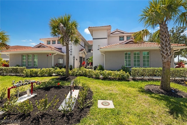 12000 Santaluz Dr Unit 202, Fort Myers, FL 33913 - mediterranean / spanish-style home with stucco siding, a front lawn, and a tile roof