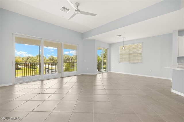 12000 Santaluz Dr Unit 202, Fort Myers, FL 33913 - unfurnished living room featuring visible vents, baseboards, ceiling fan, and light tile patterned floors