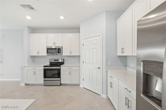 12000 Santaluz Dr Unit 202, Fort Myers, FL 33913 - kitchen with light countertops, visible vents, baseboards, appliances with stainless steel finishes, and white cabinetry