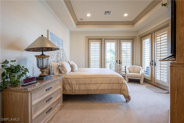 bedroom with a tray ceiling, ornamental molding, visible vents, light carpet, and access to exterior