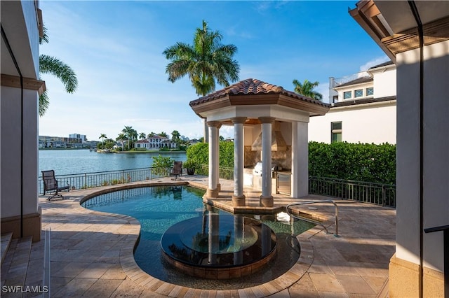 view of pool featuring a water view, fence, and a patio