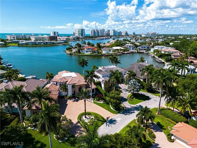 drone / aerial view with a city view, a residential view, and a water view