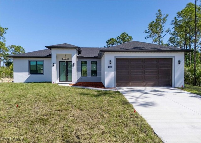 3314 43rd St W, Lehigh Acres, FL 33971 - prairie-style home featuring an attached garage, driveway, stucco siding, and a front lawn