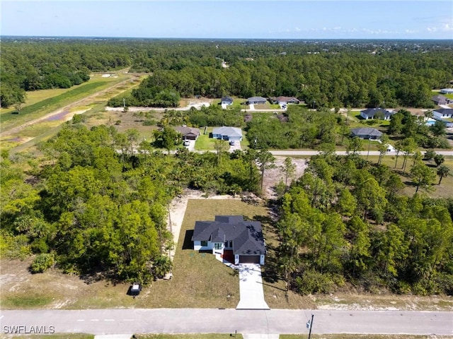 3314 43rd St W, Lehigh Acres, FL 33971 - bird's eye view with a wooded view and a residential view