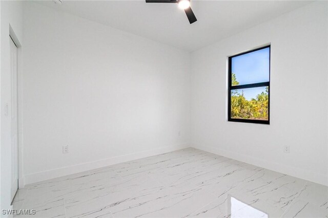 3314 43rd St W, Lehigh Acres, FL 33971 - spare room with marble finish floor, baseboards, and a ceiling fan