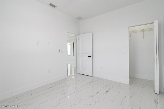 3314 43rd St W, Lehigh Acres, FL 33971 - unfurnished bedroom featuring visible vents, baseboards, a closet, a spacious closet, and marble finish floor