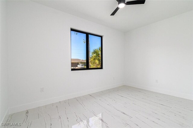 3314 43rd St W, Lehigh Acres, FL 33971 - unfurnished room featuring ceiling fan, marble finish floor, and baseboards