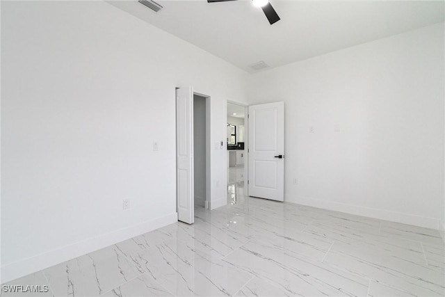 3314 43rd St W, Lehigh Acres, FL 33971 - spare room with marble finish floor, visible vents, baseboards, and ceiling fan