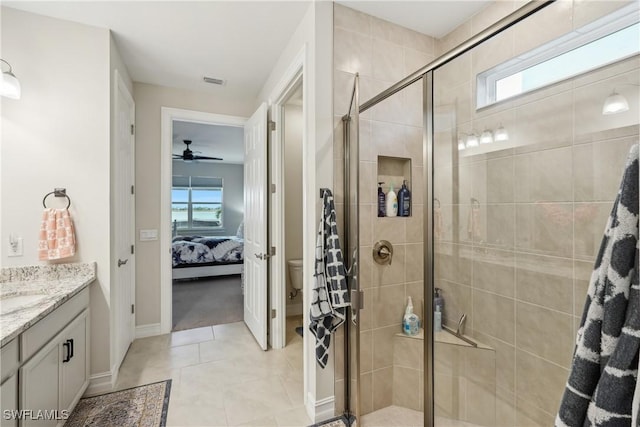 847 Stonewater Lake Ter, Cape Coral, FL 33993 - ensuite bathroom featuring a stall shower, toilet, baseboards, vanity, and a ceiling fan