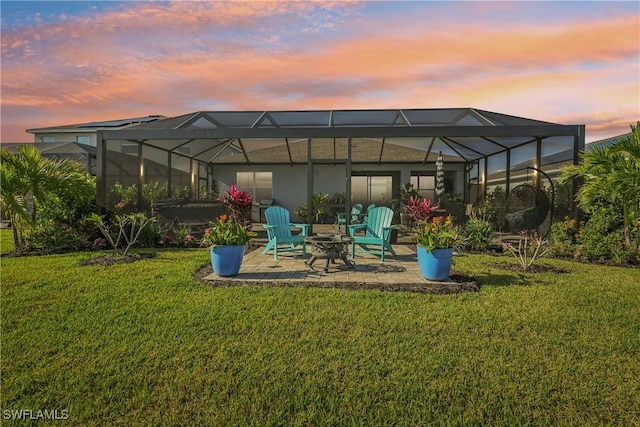 847 Stonewater Lake Ter, Cape Coral, FL 33993 - back of property with a patio area, a yard, a fire pit, and glass enclosure