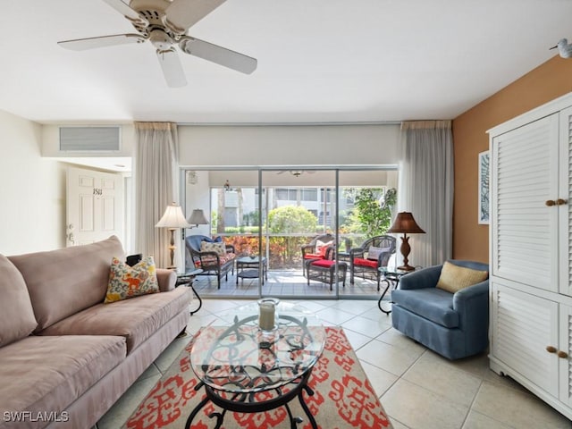 living area with light tile patterned flooring, ceiling fan, and visible vents