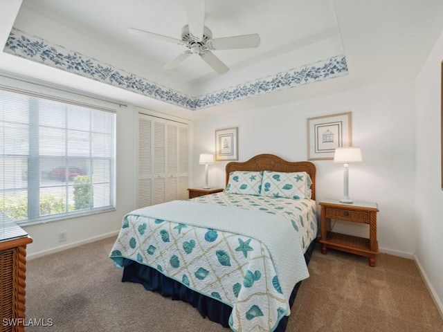 bedroom with carpet, a closet, and baseboards