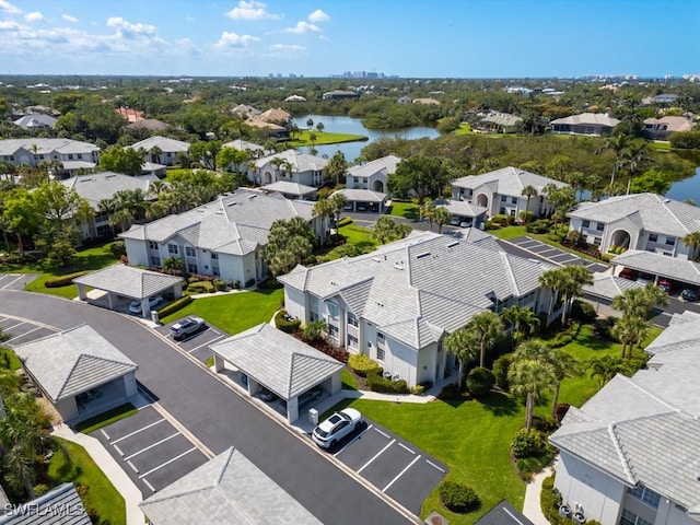 drone / aerial view with a residential view and a water view
