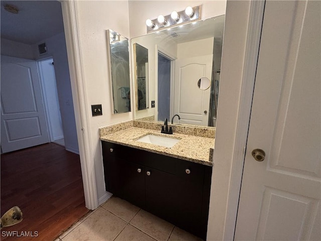 bathroom with tile patterned flooring, vanity, and visible vents