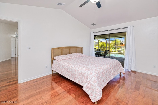 205 SW 42nd Ter, Cape Coral, FL 33914 - bedroom featuring vaulted ceiling, access to exterior, wood finished floors, and baseboards