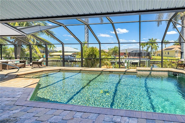 205 SW 42nd Ter, Cape Coral, FL 33914 - outdoor pool featuring a patio, glass enclosure, and a residential view