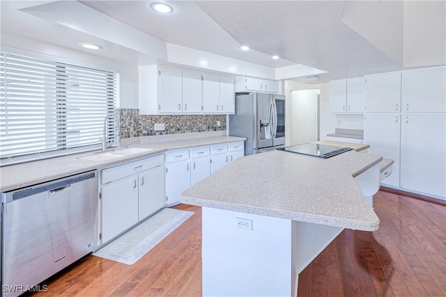 205 SW 42nd Ter, Cape Coral, FL 33914 - kitchen featuring appliances with stainless steel finishes, light wood-style floors, white cabinetry, light countertops, and recessed lighting