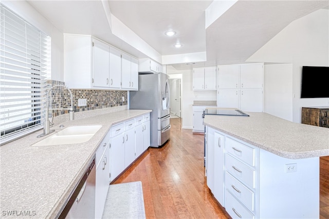 205 SW 42nd Ter, Cape Coral, FL 33914 - kitchen with a sink, stainless steel appliances, light wood-style flooring, a kitchen island, and light countertops