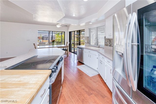 205 SW 42nd Ter, Cape Coral, FL 33914 - kitchen with appliances with stainless steel finishes, a sink, a ceiling fan, light wood-type flooring, and white cabinets