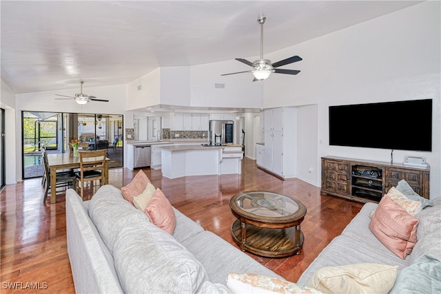 205 SW 42nd Ter, Cape Coral, FL 33914 - living area featuring ceiling fan, light wood-style floors, baseboards, and high vaulted ceiling