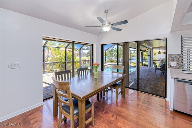 205 SW 42nd Ter, Cape Coral, FL 33914 - dining area featuring ceiling fan, vaulted ceiling, baseboards, and wood finished floors