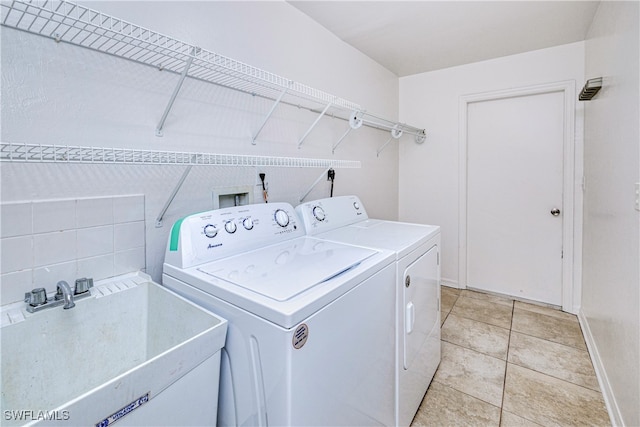 205 SW 42nd Ter, Cape Coral, FL 33914 - laundry area with washer and dryer, baseboards, and light tile patterned flooring