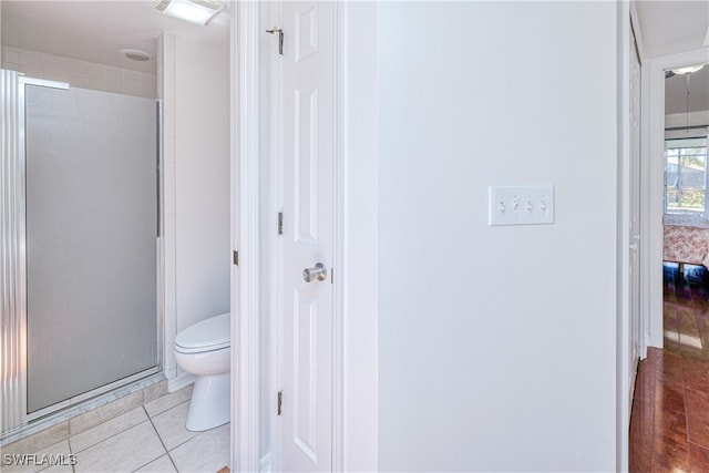 205 SW 42nd Ter, Cape Coral, FL 33914 - bathroom featuring a shower stall, toilet, and tile patterned flooring