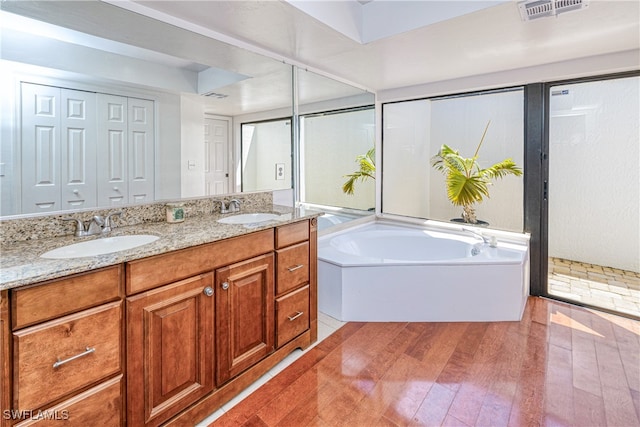 205 SW 42nd Ter, Cape Coral, FL 33914 - full bath featuring wood finished floors, double vanity, and a bath