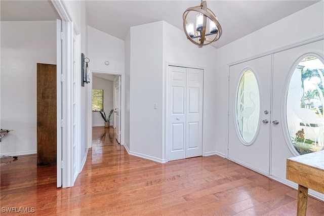 205 SW 42nd Ter, Cape Coral, FL 33914 - foyer entrance with light wood-style floors, a chandelier, baseboards, and french doors