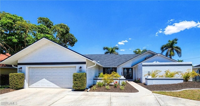 205 SW 42nd Ter, Cape Coral, FL 33914 - ranch-style house featuring an attached garage, driveway, french doors, and stucco siding